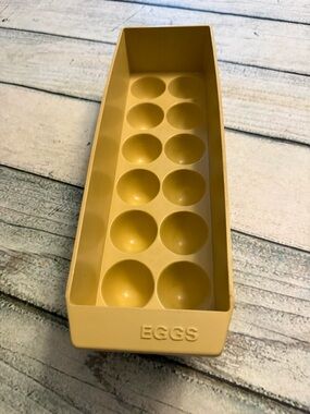 Vintage plastic egg storage container designed to hold 12 eggs.